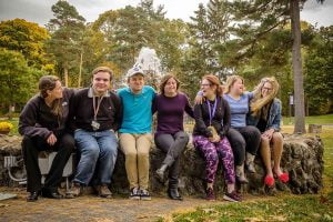8 students sitting by fountain at Nazareth College