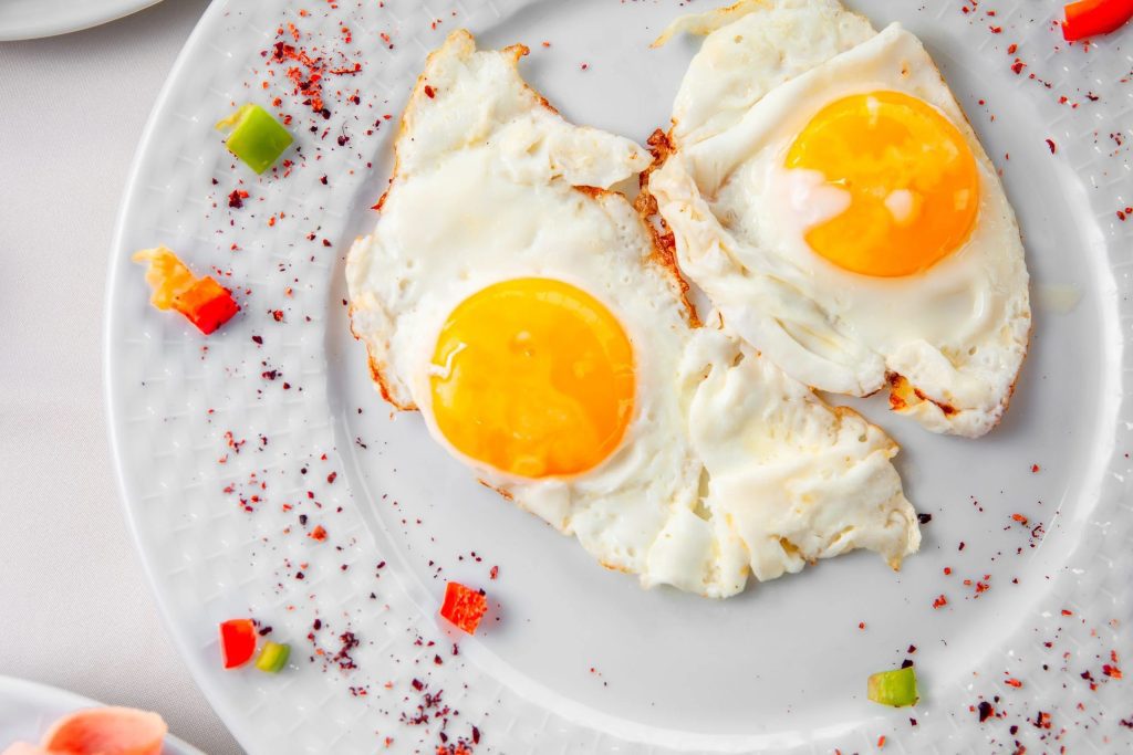 fried eggs plate white backgroun